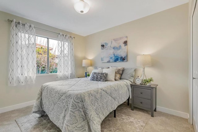 bedroom featuring light carpet