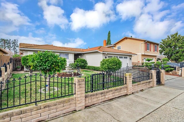 view of front of property featuring a garage and a front lawn