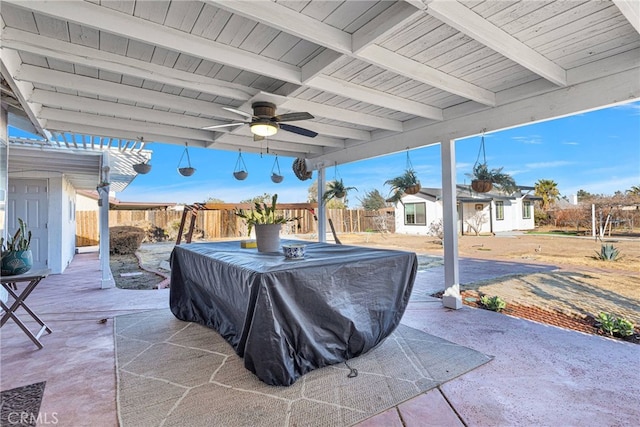 view of patio with an outdoor structure and ceiling fan