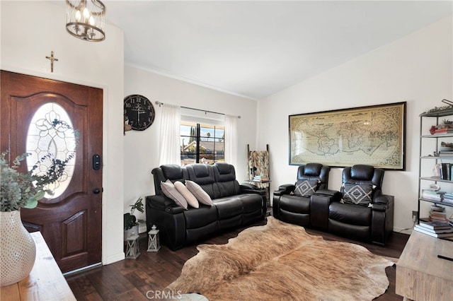 living room with vaulted ceiling, dark wood-type flooring, and a chandelier