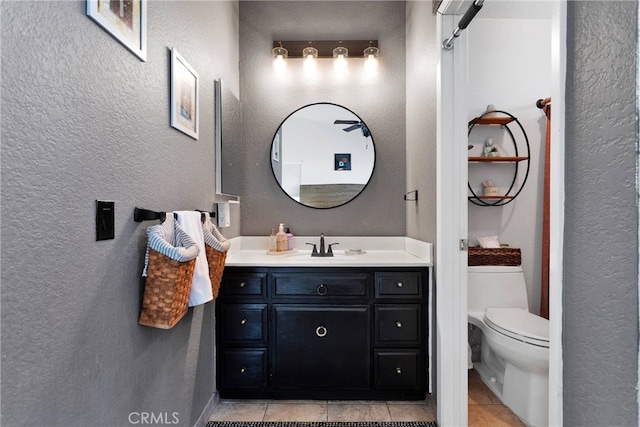 bathroom with vanity, tile patterned floors, and toilet