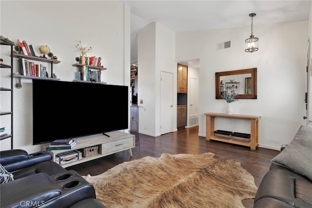 living room featuring dark hardwood / wood-style floors and high vaulted ceiling