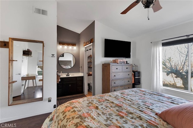 bedroom featuring ensuite bathroom, lofted ceiling, and dark hardwood / wood-style flooring