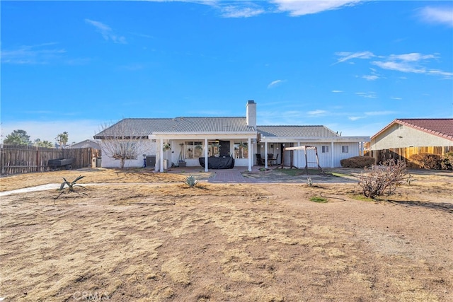 rear view of property featuring a patio area