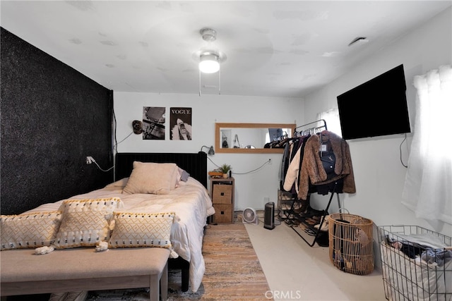 bedroom with wood-type flooring and ceiling fan