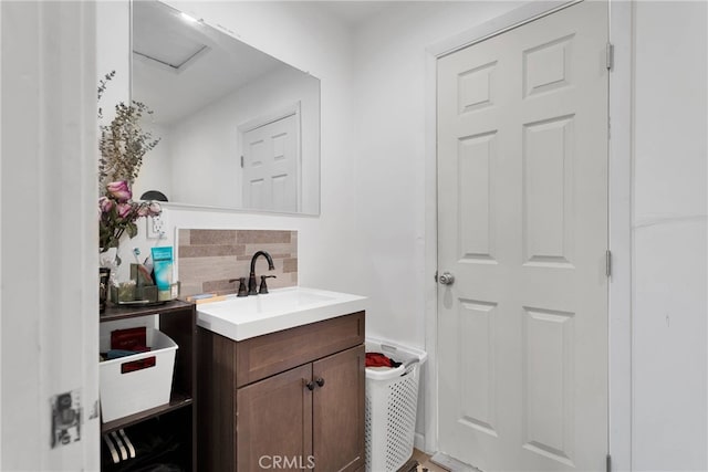 bathroom featuring vanity and backsplash