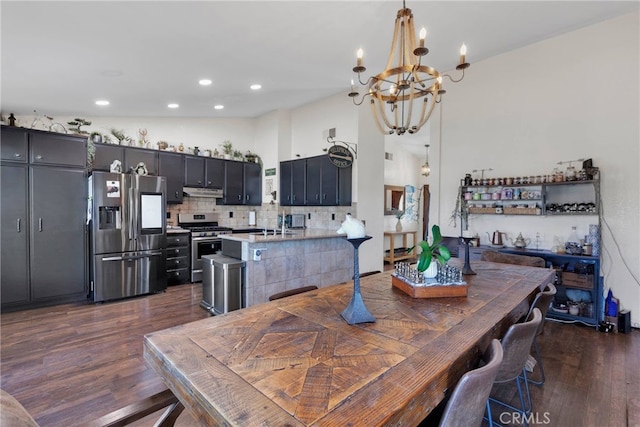 dining space with high vaulted ceiling, sink, a chandelier, and dark hardwood / wood-style flooring