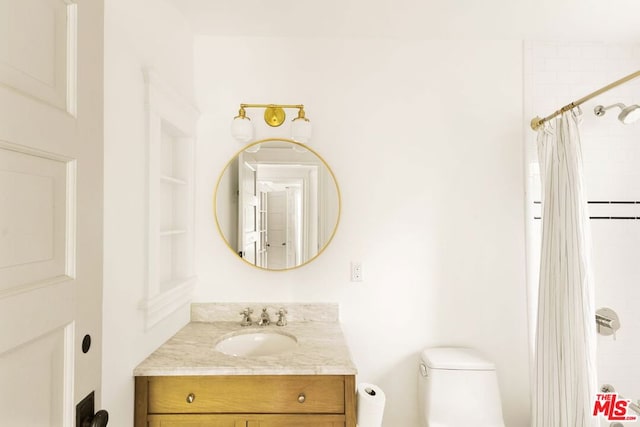 bathroom with a shower with curtain, vanity, and toilet