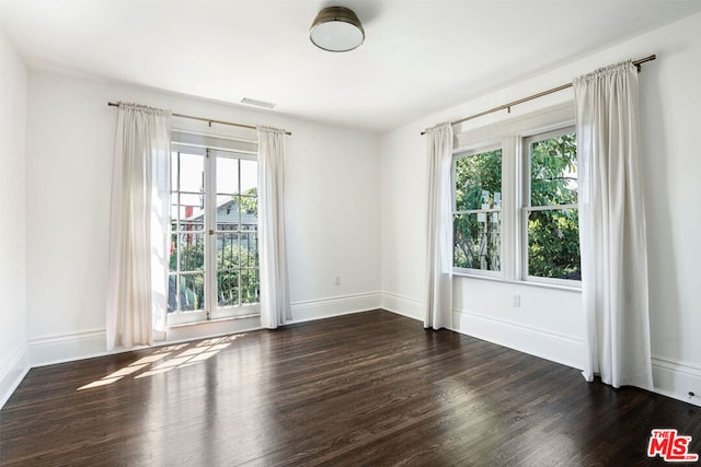 spare room featuring dark wood-type flooring