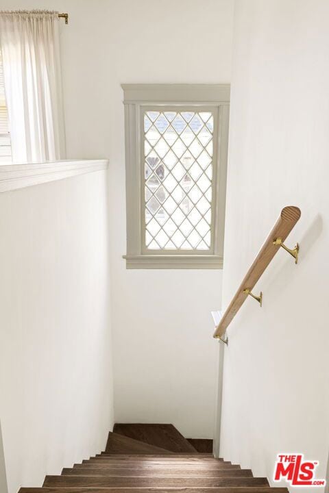 stairs featuring hardwood / wood-style floors