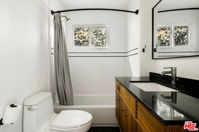 full bathroom featuring shower / bathtub combination with curtain, vanity, and toilet