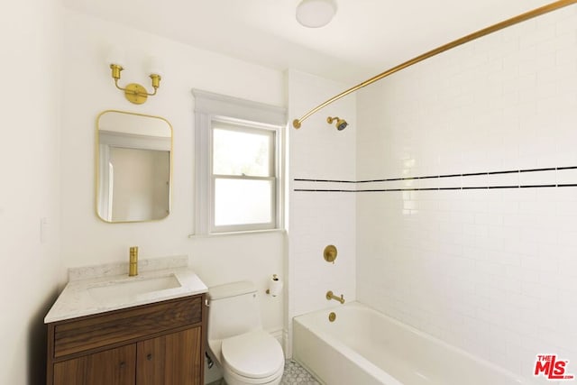 full bathroom featuring tiled shower / bath combo, vanity, and toilet