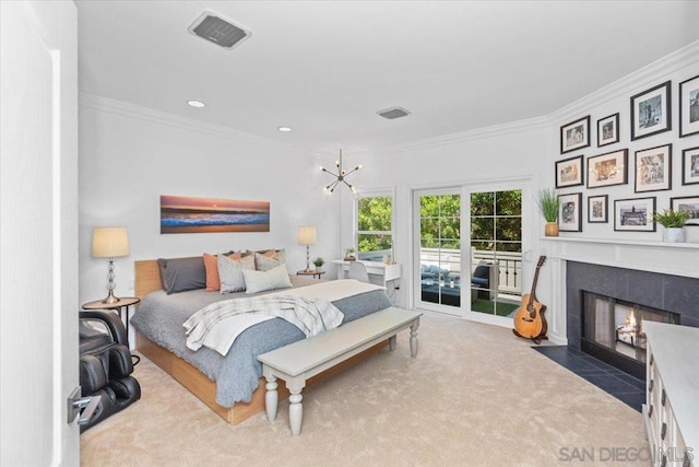 carpeted bedroom featuring crown molding, a fireplace, access to exterior, and a notable chandelier