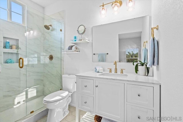 bathroom featuring vanity, a shower with shower door, tile patterned floors, and toilet