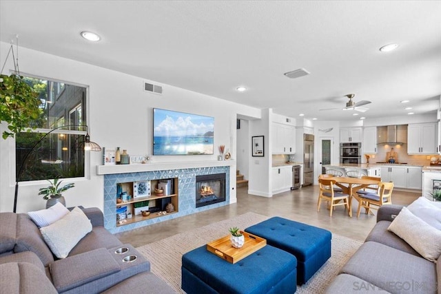 living room featuring ceiling fan and beverage cooler