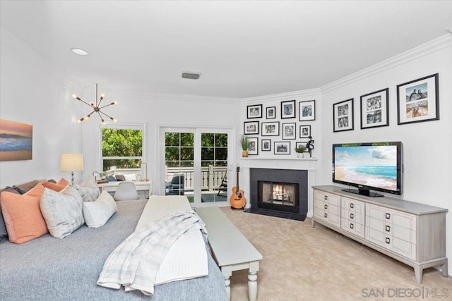 carpeted bedroom featuring access to exterior, ornamental molding, and a chandelier