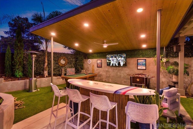 exterior space with exterior bar and ceiling fan