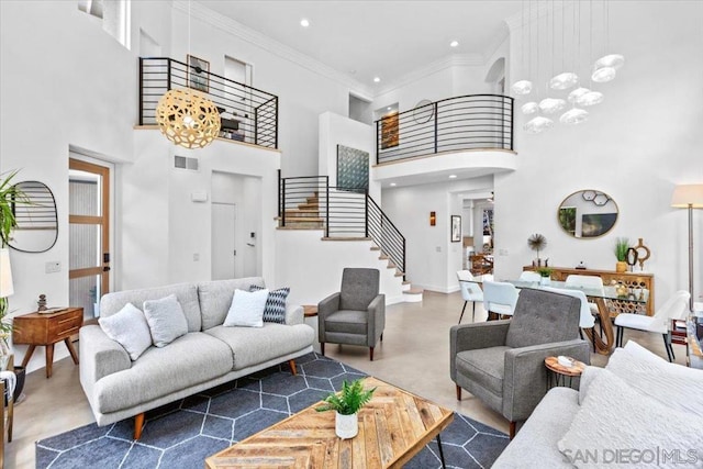 living room with concrete flooring, crown molding, a high ceiling, and an inviting chandelier