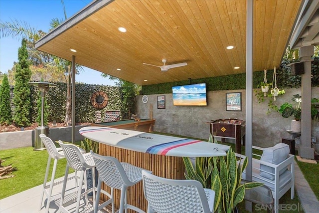 view of patio featuring an outdoor bar and ceiling fan