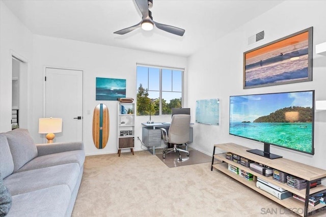 home office featuring ceiling fan and light carpet