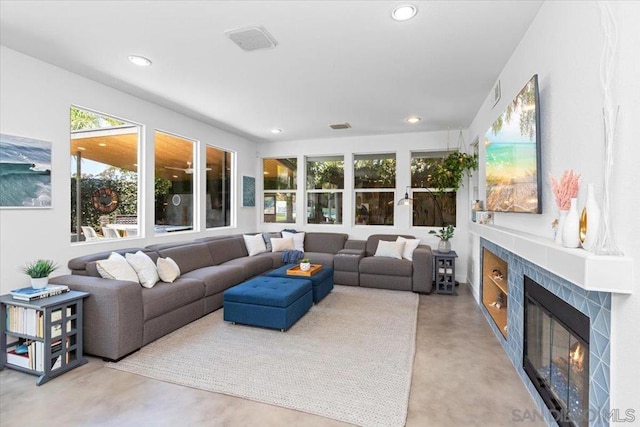 living room featuring a tile fireplace