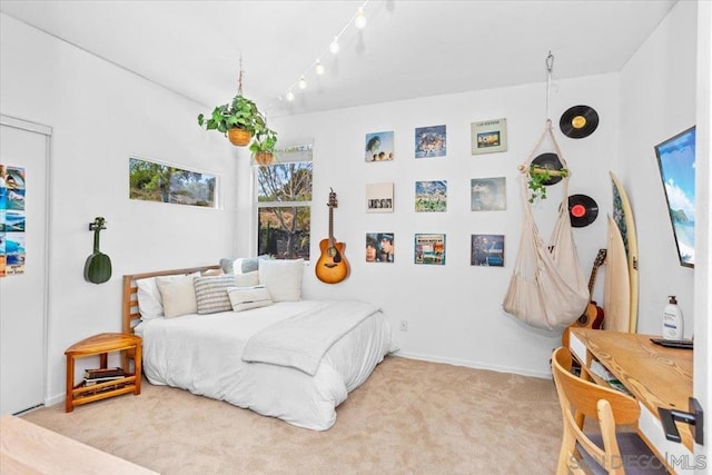 bedroom with carpet floors and track lighting