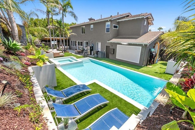 view of swimming pool featuring a lawn, central AC unit, a patio area, an outdoor hangout area, and an in ground hot tub