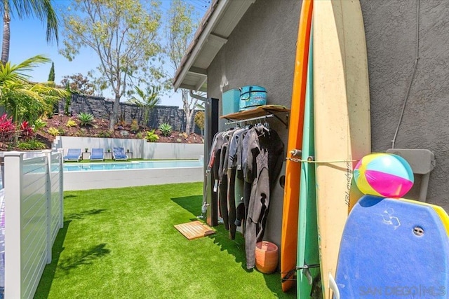 exterior space with a pool and a lawn