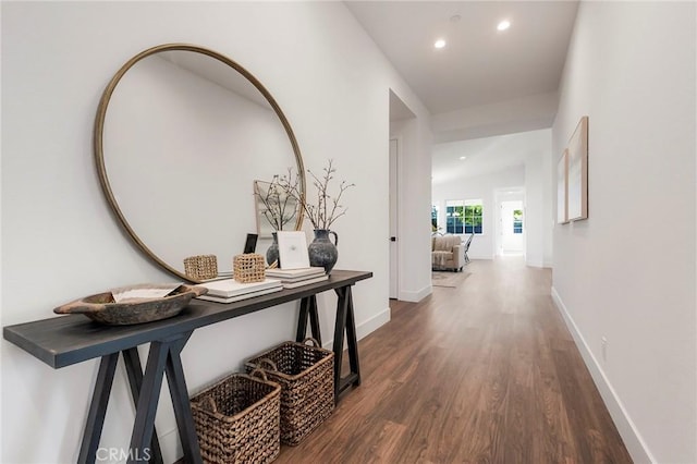 hallway with dark hardwood / wood-style flooring