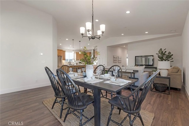 dining space featuring an inviting chandelier, dark hardwood / wood-style floors, and vaulted ceiling