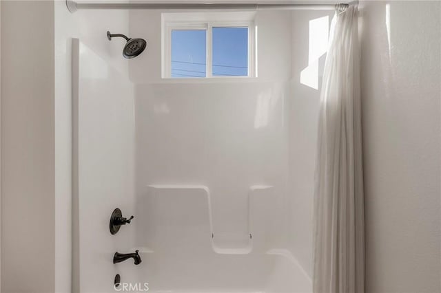 bathroom with shower / bathtub combination with curtain