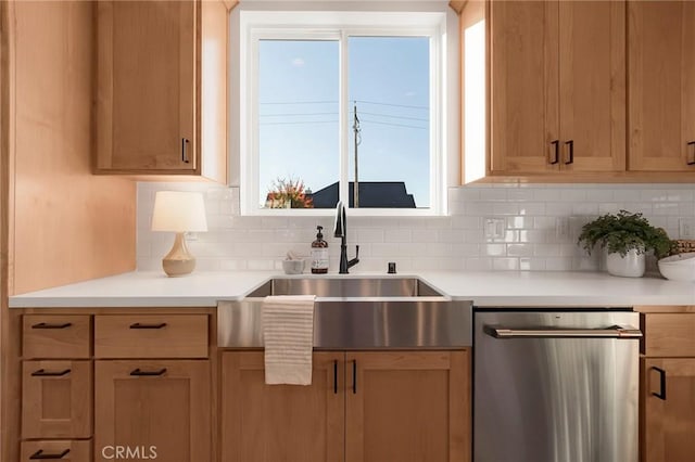 kitchen featuring tasteful backsplash, sink, and dishwasher