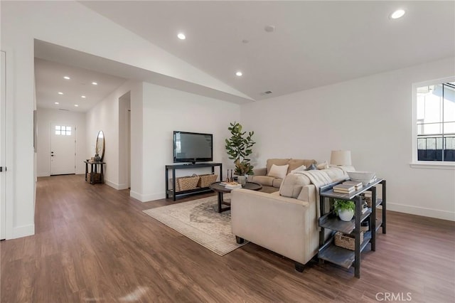 living room with vaulted ceiling, plenty of natural light, and dark hardwood / wood-style floors