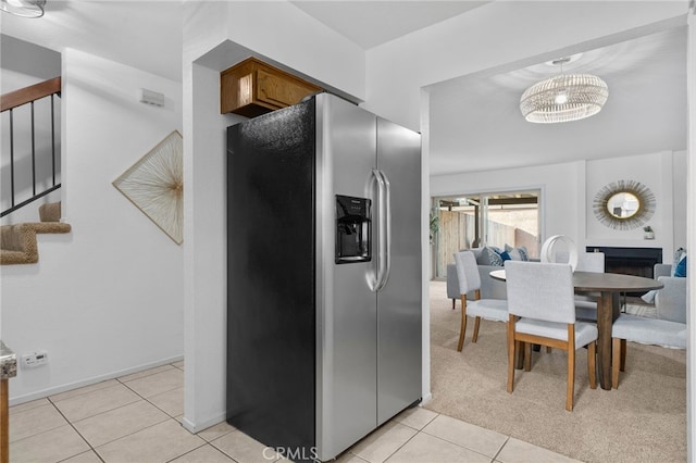 kitchen with light tile patterned flooring and stainless steel fridge with ice dispenser