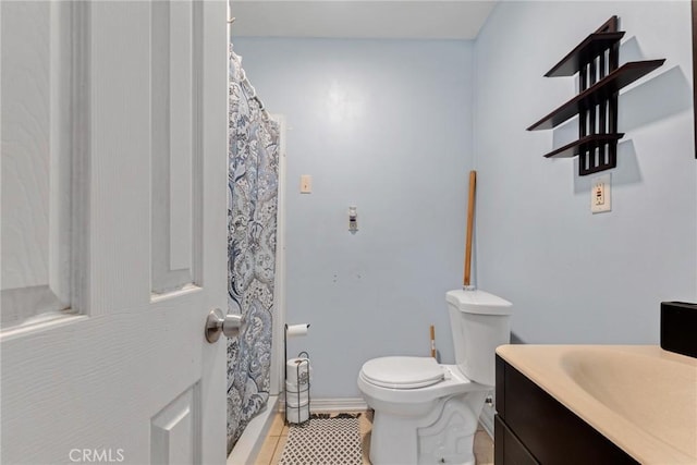 bathroom featuring vanity, a shower with shower curtain, tile patterned floors, and toilet