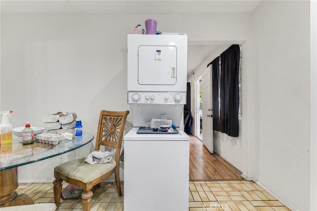 clothes washing area with stacked washer / drying machine