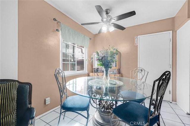 dining space with light tile patterned floors and ceiling fan