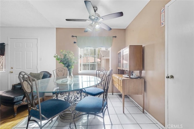 tiled dining space featuring ceiling fan