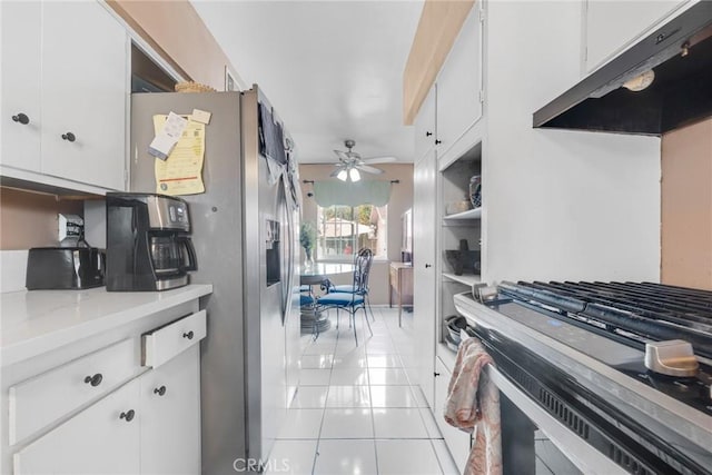 kitchen with stainless steel appliances, light tile patterned flooring, white cabinets, and ceiling fan