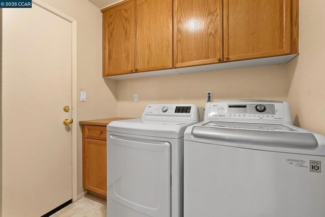 laundry area with cabinets and washing machine and dryer