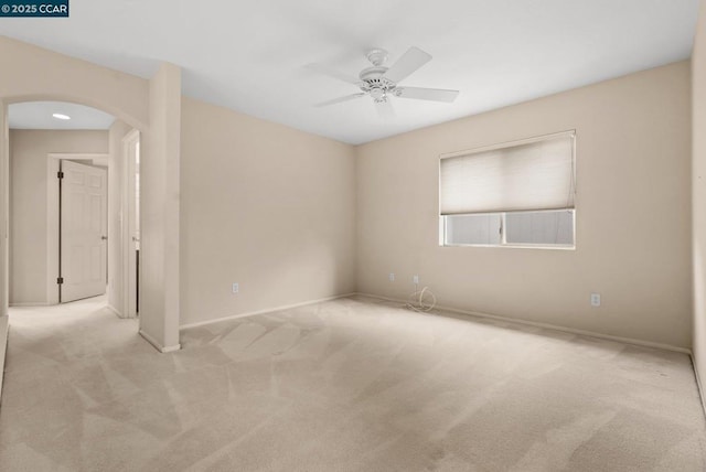 carpeted spare room featuring ceiling fan