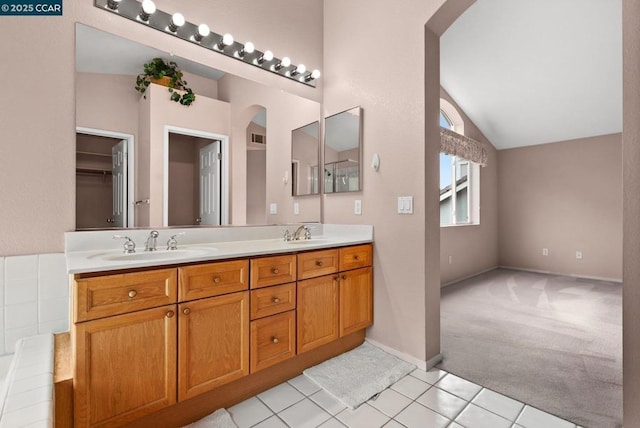 bathroom featuring lofted ceiling, tile patterned flooring, and vanity