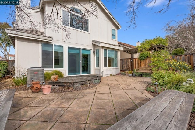 rear view of house featuring a patio and central air condition unit