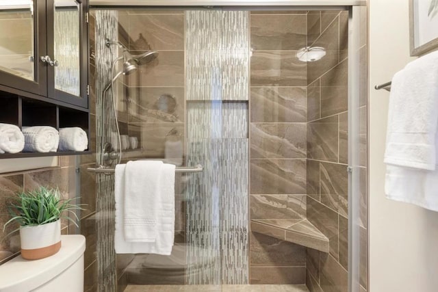 bathroom featuring toilet and an enclosed shower