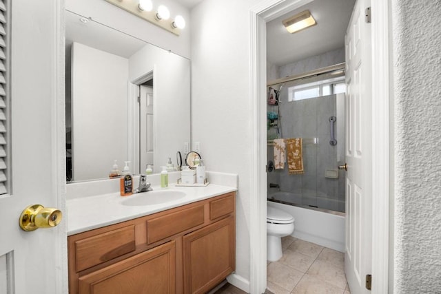 full bathroom featuring vanity, tile patterned flooring, shower / bath combination with glass door, and toilet