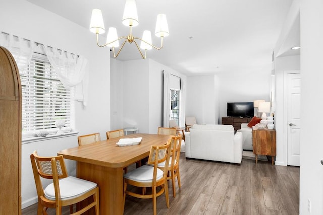 dining space featuring an inviting chandelier and wood-type flooring