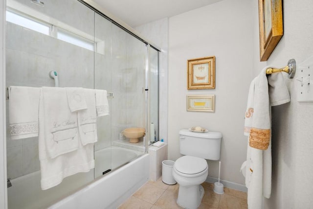 bathroom with enclosed tub / shower combo, toilet, and tile patterned flooring