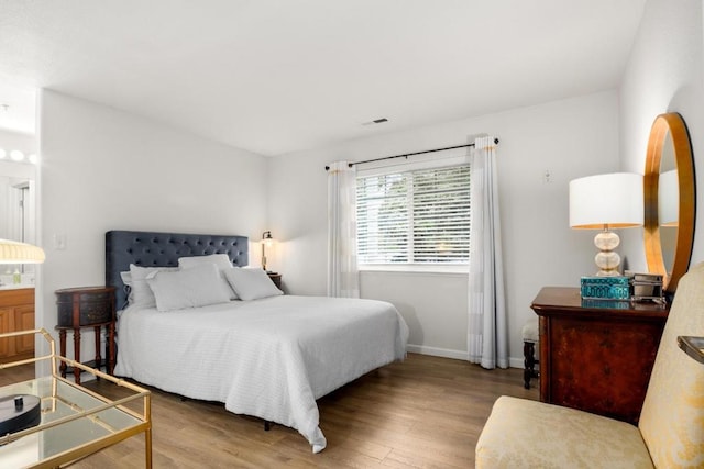 bedroom with hardwood / wood-style flooring