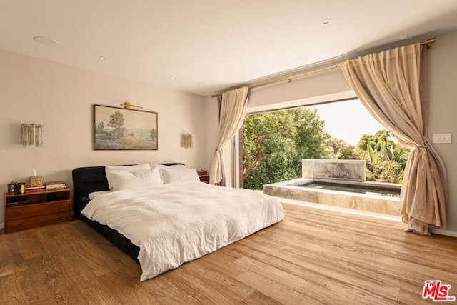 bedroom with wood-type flooring