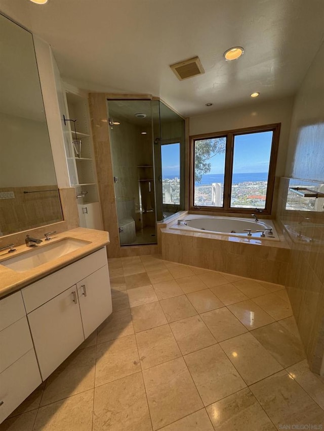 bathroom with independent shower and bath, vanity, and tile patterned flooring